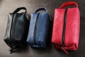 Three bags, black, blue and red with genuine leather locks on a black background Royalty Free Stock Photo