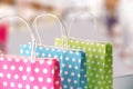 Three bags colored in a row on table in mall Royalty Free Stock Photo