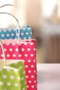 Three bags colored on table in a shop detail Royalty Free Stock Photo