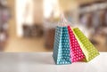 Three bags colored on table in a shop front Royalty Free Stock Photo