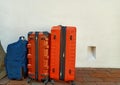 Three bags beside the house wall, white on the floor