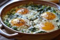 Three baked eggs over spinach in ceramic dish. Artificial intelligence image Royalty Free Stock Photo