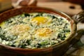 Three baked eggs over spinach in ceramic dish. Neural network AI generated Royalty Free Stock Photo