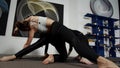 Three ballerinas are stretching at the floor on black mats