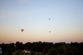 Three balloons in the background of sunset sky