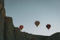 Three balloons fly at sunset