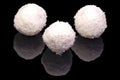 Three balls with coconuts, isolated on black background Royalty Free Stock Photo