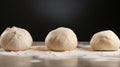 Three Balls of Dough on Floured SurfaceâSoft Texture Against Dark Background Royalty Free Stock Photo