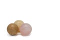 Three balls made of natural stone. Rose quartz, yellow calcide and jasper. Isolated on white, copy space