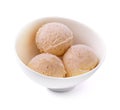 Three balls of vanilla-banana ice cream in white bowl