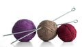 Three balls of yarn in different colors with knitting needles. Royalty Free Stock Photo