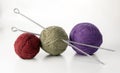 Three balls of yarn in different colors with knitting needles Royalty Free Stock Photo