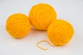 Three balls of yellow thread for knitting or crocheting Royalty Free Stock Photo
