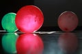 Three baloons and their reflections on the floor