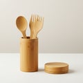Three bamboo kitchen utensilsâa spoon and two forksâstand upright in a cylindrical Royalty Free Stock Photo