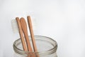 bamboo tooth brushes in a glass jar on a white background, copy space Royalty Free Stock Photo