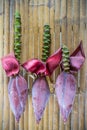 Three banana blossoms cut from banana trees.