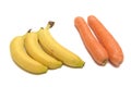 Three banana wedges and a pair of carrots white backdrop