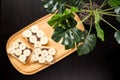 Three banana white bread toasts spread with chocolate butter that lie on a chopping board with a sprig of leaves on a dark