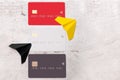 Three bank cards on a light background. Near paper planes. The concept of movement and waste of money.