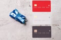 Three bank cards on a light background. Near paper scrolls. Creativity, wish list.