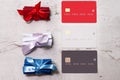 Three bank cards on a light background. Near paper scrolls. Creativity, wish list.