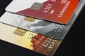 Three bank credit cards with chips of different colors on a black