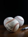 Three baseballs on wood table