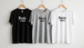 Three basic t-shirts in different colors including black, grey, and white, displayed on hangers against a simple white wall, ai Royalty Free Stock Photo