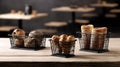 Three baskets of bread and pastries on a wooden table with blurred background of a cafe Royalty Free Stock Photo