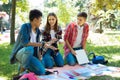 Three beaming art students working on project outside