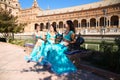 Three beautiful adult belly dancers are sitting on a park bench. They are talking and having fun with each other. Concept of