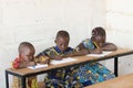 Three beautiful African Children in School Taking Notes during C