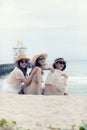 Three beautiful asian younger woman laughing with relaxing emotion at vacation sea side Royalty Free Stock Photo