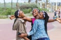 Three beautiful black young women laughing and celebrating a birthday outdoors in Durban, South Africa