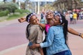 Three beautiful black young women laughing and celebrating a birthday outdoors in Durban, South Africa