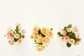 Three beautiful bouquets of pink and cream roses in white vases Royalty Free Stock Photo