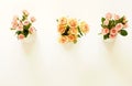 Three beautiful bouquets of pink and cream roses in white vases Royalty Free Stock Photo