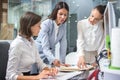 Three beautiful business women working together on project at office desk Royalty Free Stock Photo