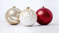 Three beautiful Christmas ornaments in red, white and gold with white background Royalty Free Stock Photo