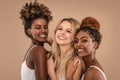Three Beautiful Diverse Girls Posing together, smiling and looking at camera