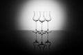 Three beautiful elegant glasses for grappa backlight, with reflection Royalty Free Stock Photo