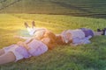 Three beautiful girl are laying on the sunny glade with smail an Royalty Free Stock Photo