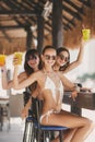 Three beautiful girls in a bar on the beach Royalty Free Stock Photo