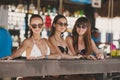 Three beautiful girls in a bar on the beach Royalty Free Stock Photo