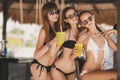 Three beautiful girls in a bar on the beach Royalty Free Stock Photo