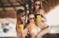 Three beautiful girls in a bar on the beach Royalty Free Stock Photo