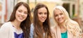 Three beautiful girls drinking coffee in cafe