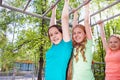 Three beautiful girls hanging on brachiating bar Royalty Free Stock Photo