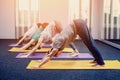 Three beautiful girls and man do yoga in the center of yoga and spa. Royalty Free Stock Photo